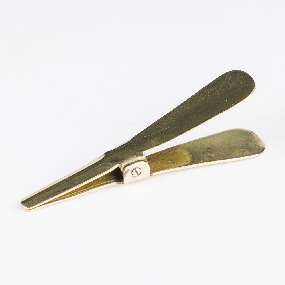 An open mahogany wooden box lined with blue velvet, containing six rounded metal egg weights and brass tweezers fitted into the lid. View XIII