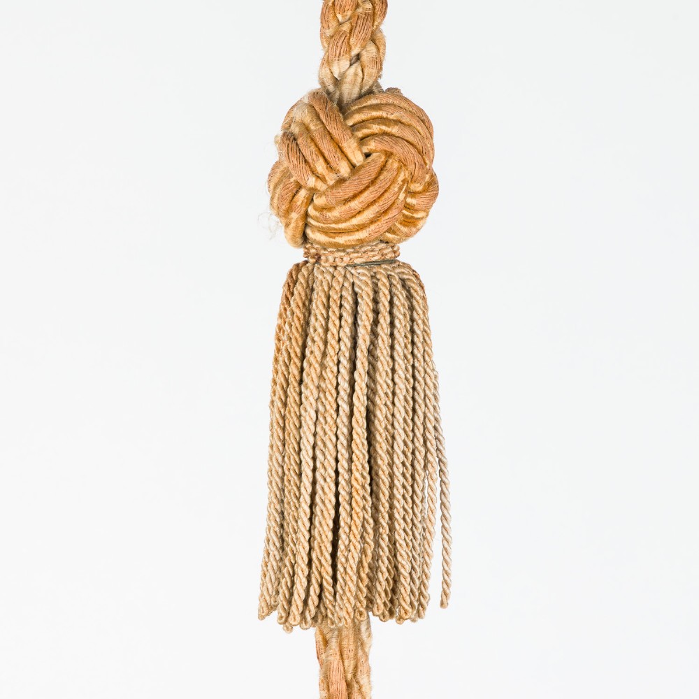 A fluted white alabaster urn-shaped light shade suspended by decorative woven cords and tassels from a matching alabaster ceiling rose. View VI