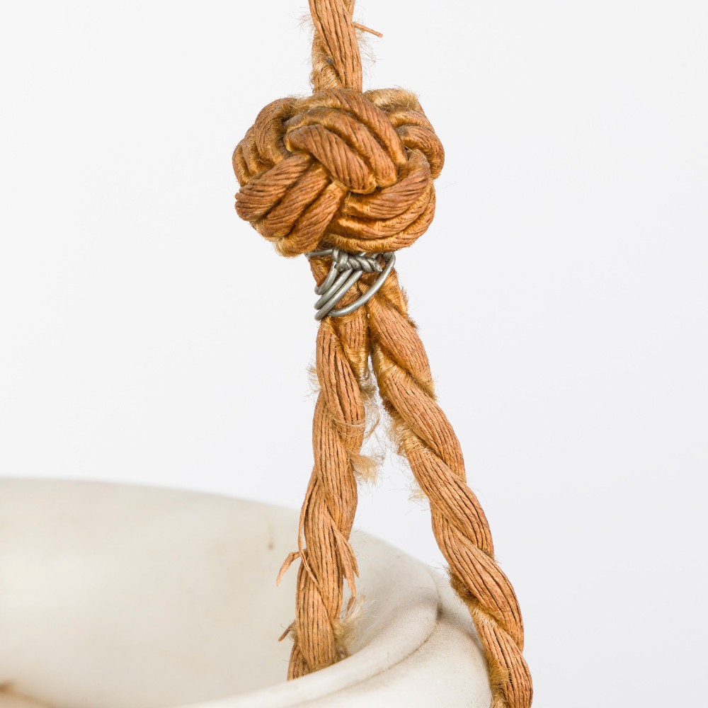 A fluted white alabaster urn-shaped light shade suspended by decorative woven cords and tassels from a matching alabaster ceiling rose. View VII