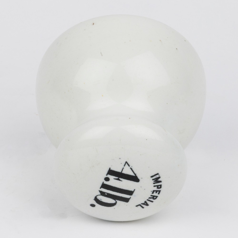 A white glazed ceramic four pound scale weight with black lettering reading Imperial 4 lb printed on top. View V