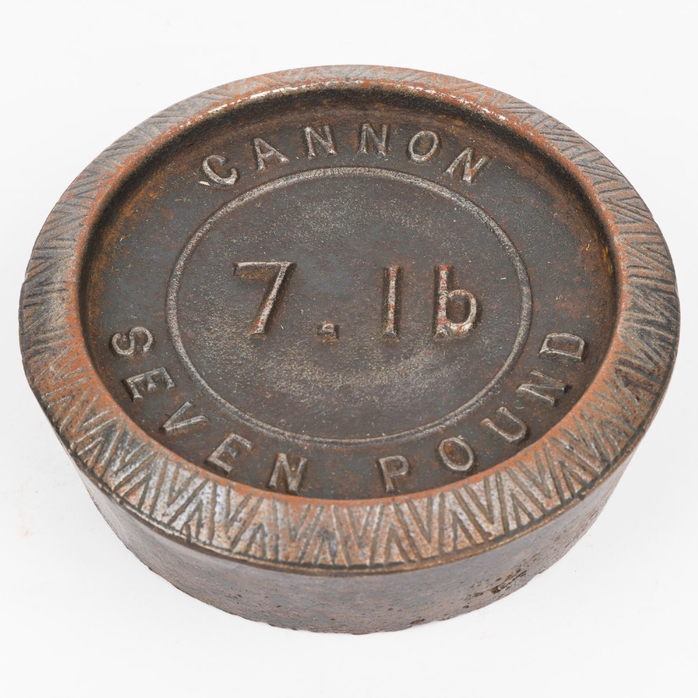 A set of six graduated cast iron nested imperial scale weights stacked into a pyramid shape, featuring textured chevron banding along the sides. View VII