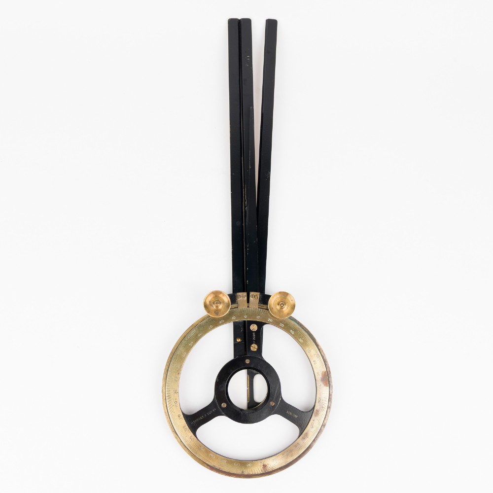 An antique brass and black lacquered three-arm station pointer with a circular graduated dial and precision adjustment knobs. View II