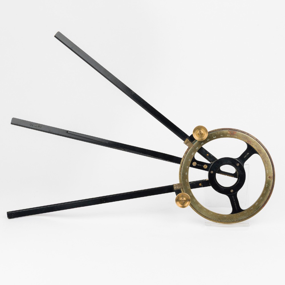 An antique brass and black lacquered three-arm station pointer with a circular graduated dial and precision adjustment knobs. View III