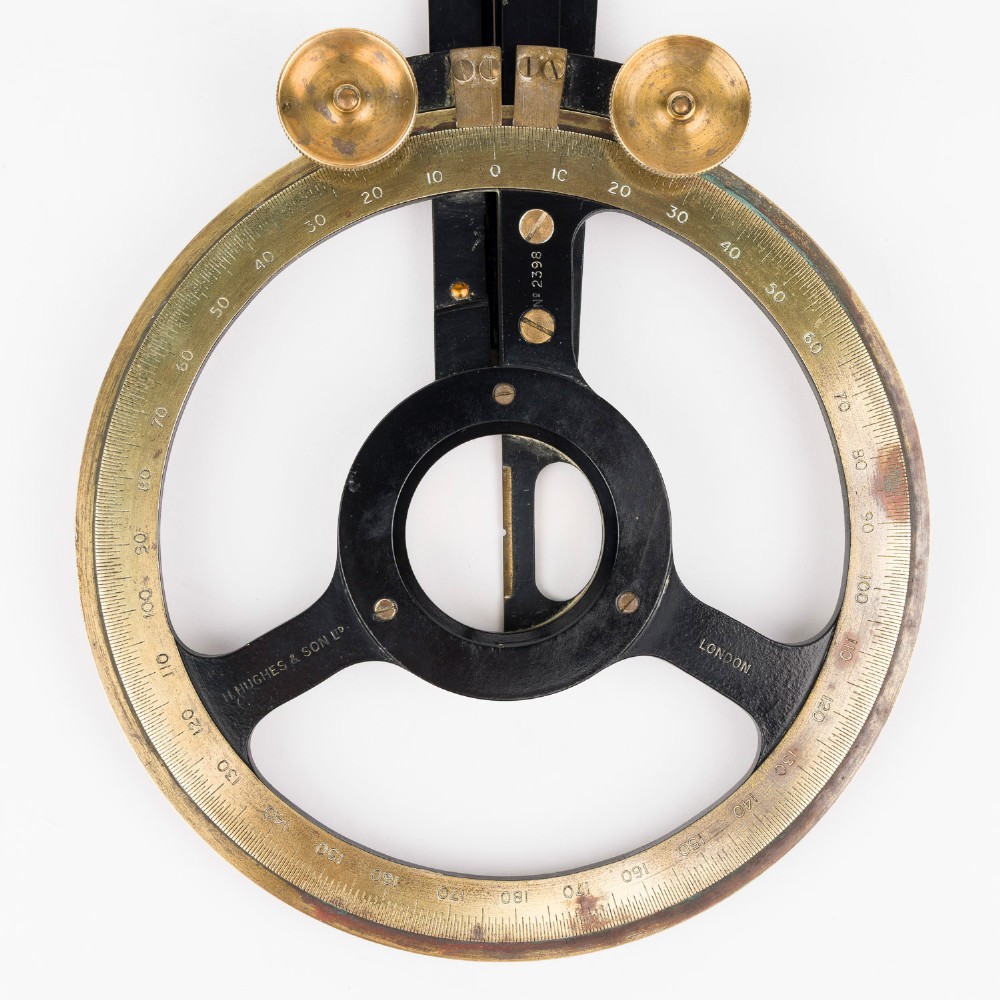 An antique brass and black lacquered three-arm station pointer with a circular graduated dial and precision adjustment knobs. View IV