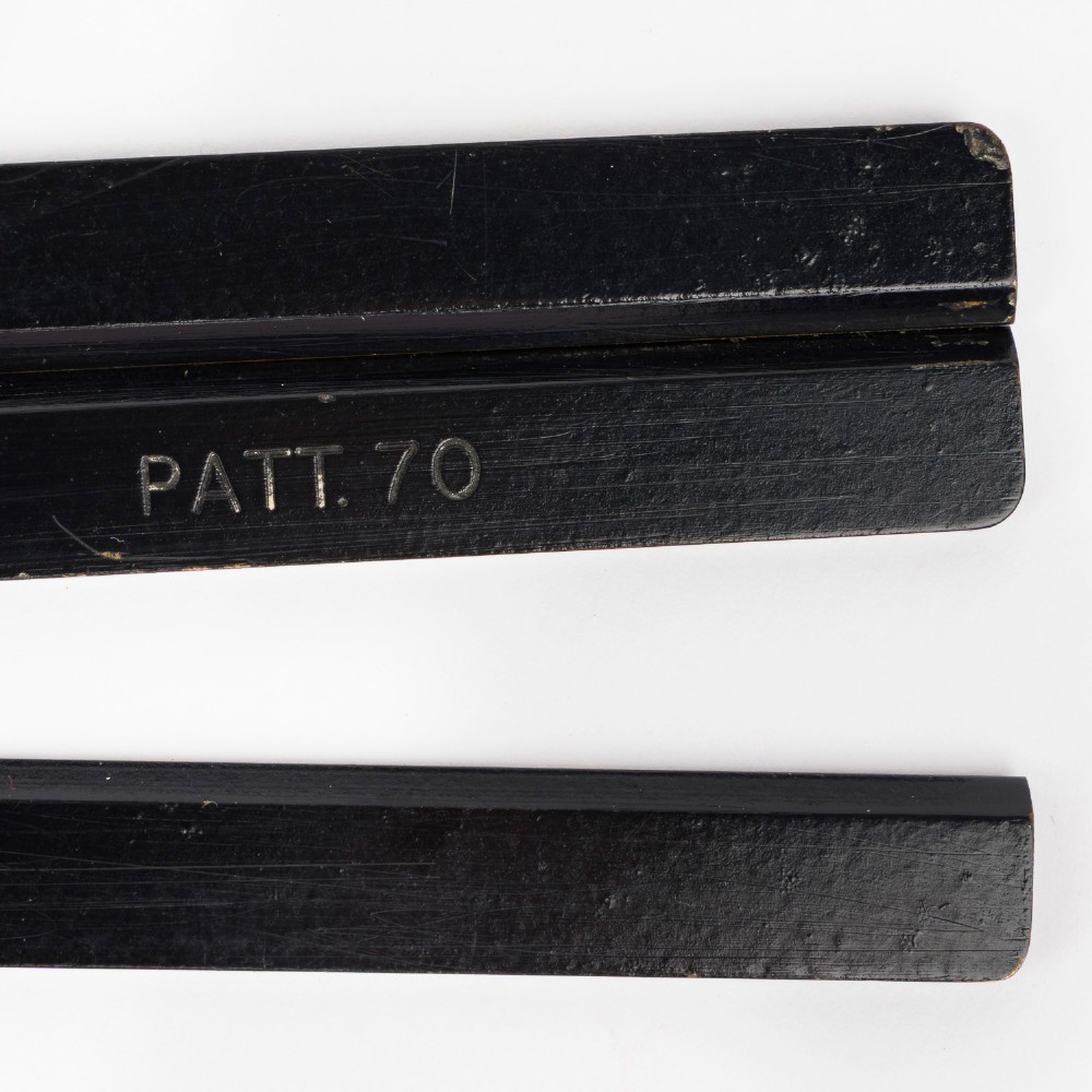 An antique brass and black lacquered three-arm station pointer with a circular graduated dial and precision adjustment knobs. View VIII