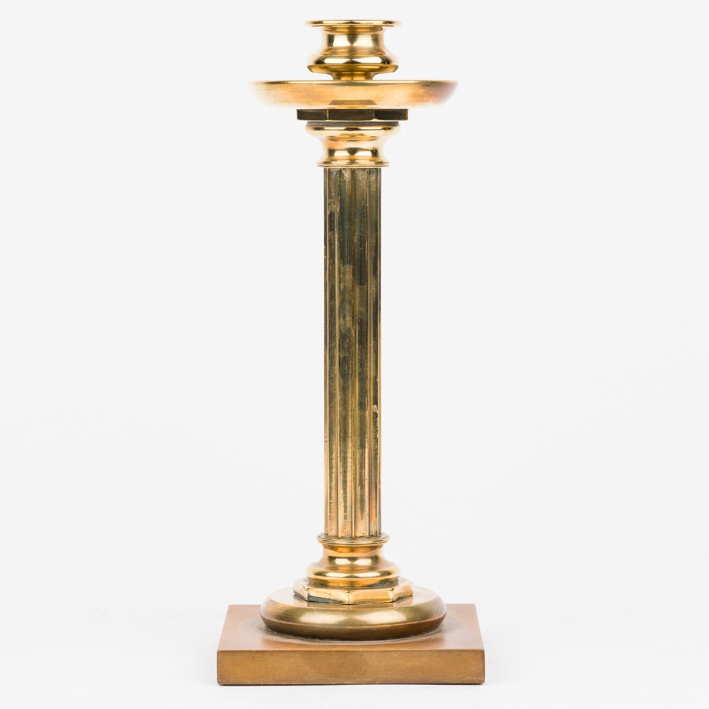 A pair of gilt bronze column candlesticks featuring fluted stems, wide circular drip trays, and square bases. View II