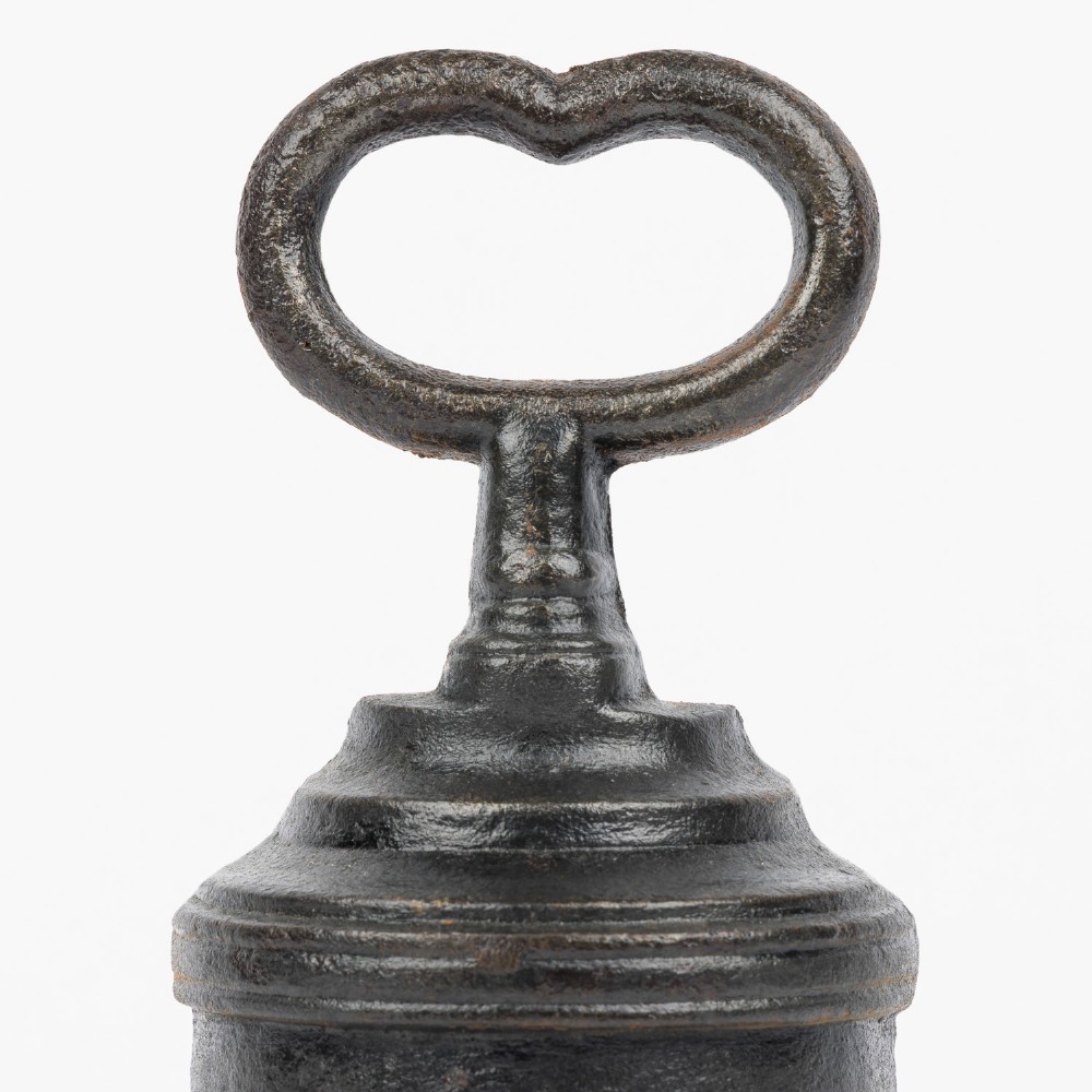 A Victorian cast iron door porter with a bell-shaped body and a heart-shaped loop handle at the top. View II