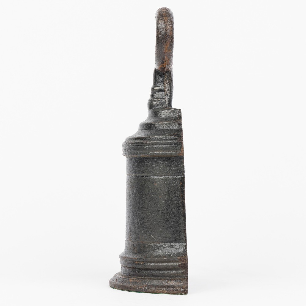 A Victorian cast iron door porter with a bell-shaped body and a heart-shaped loop handle at the top. View III