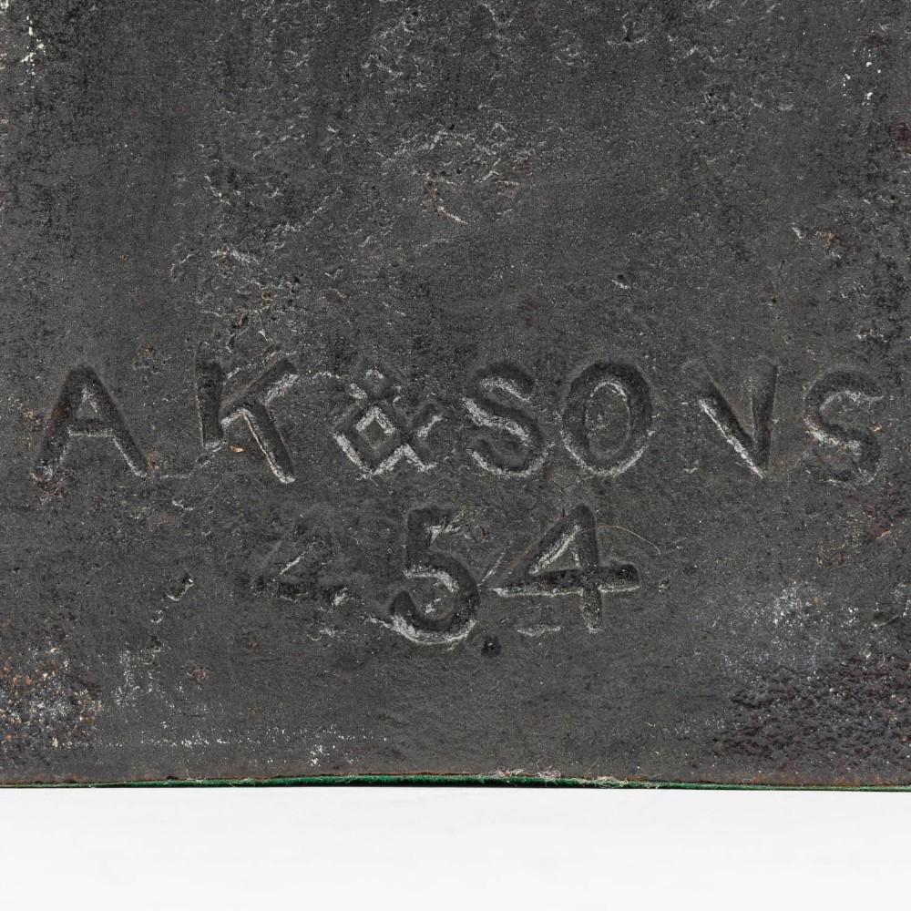 A Victorian cast iron door porter with a bell-shaped body and a heart-shaped loop handle at the top. View V