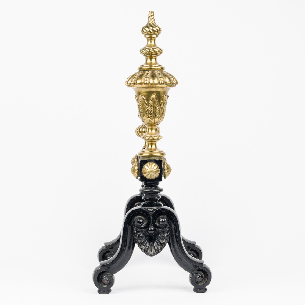 A pair of cast iron and brass fire dogs with ornate brass urn finials, fluted central bars, and black scroll feet. View III