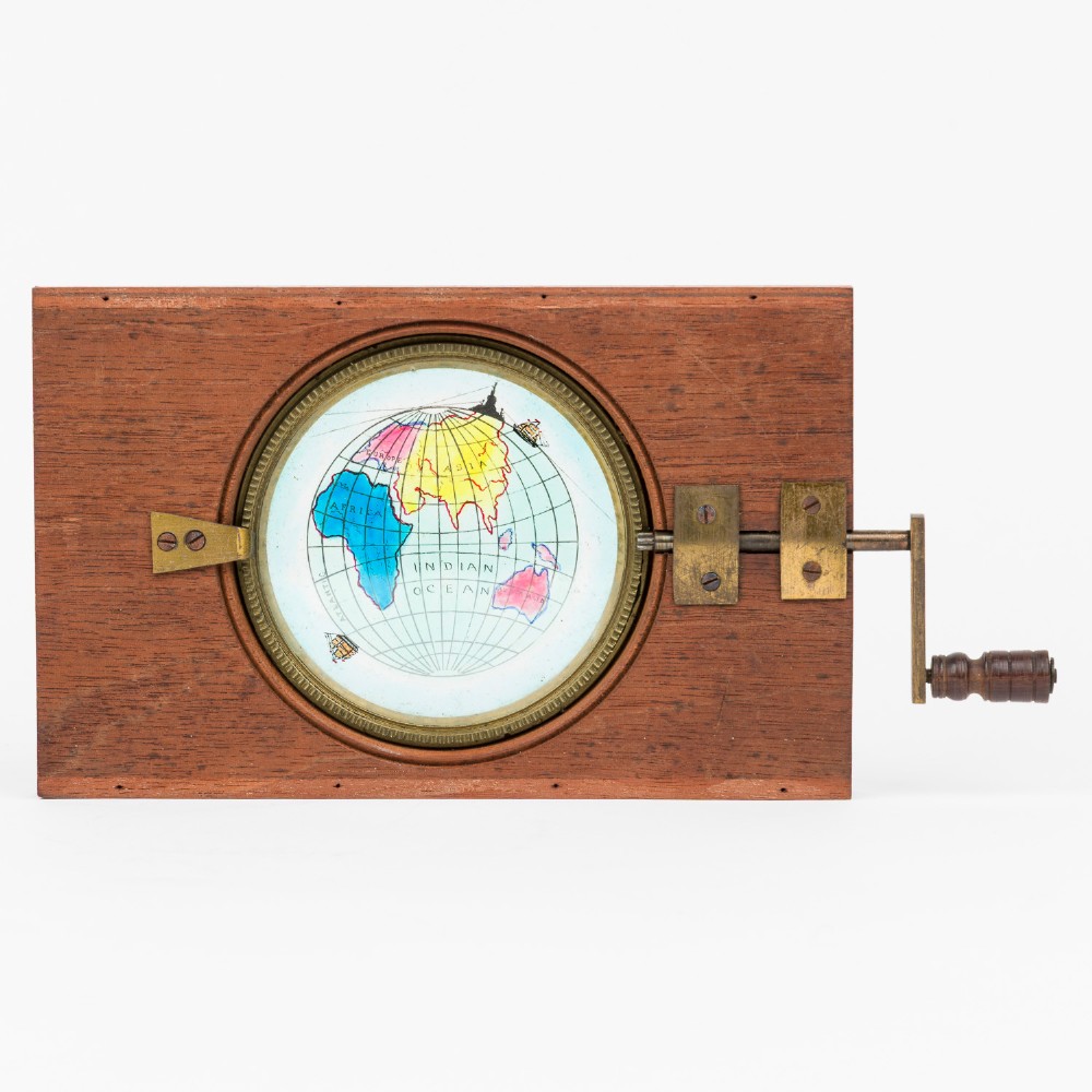 A pair of rectangular mahogany-framed mechanical magic lantern slides featuring hand-coloured astronomical glass apertures and brass hand cranks. View V