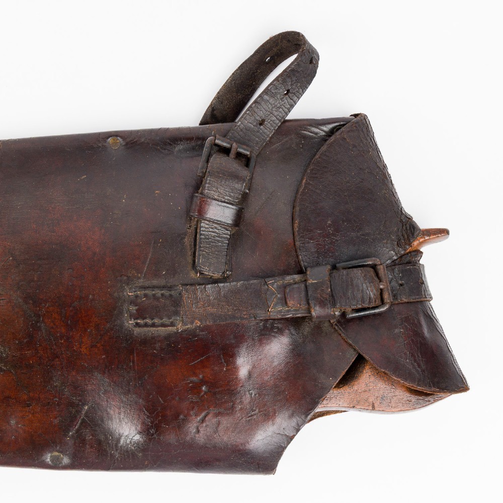 An antique steel hand saw featuring a patinated blade with visible teeth and a shaped wooden handle secured with metal rivets. View VI