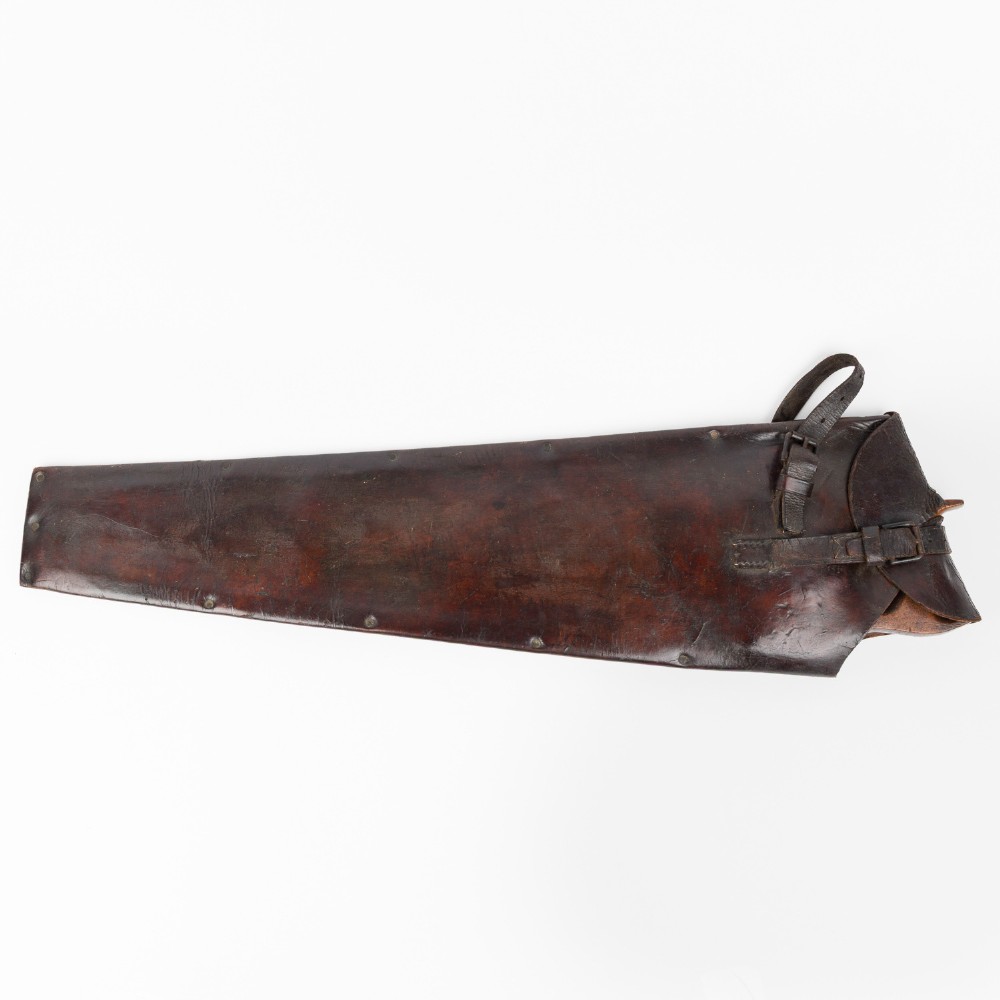 An antique steel hand saw featuring a patinated blade with visible teeth and a shaped wooden handle secured with metal rivets. View IX