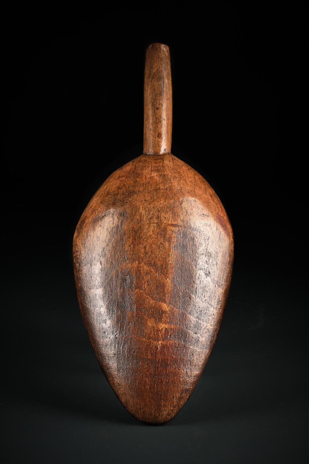 A hand-carved dark beechwood flour and grain scoop with a tapered cylindrical handle and rich patinated surface. View IV