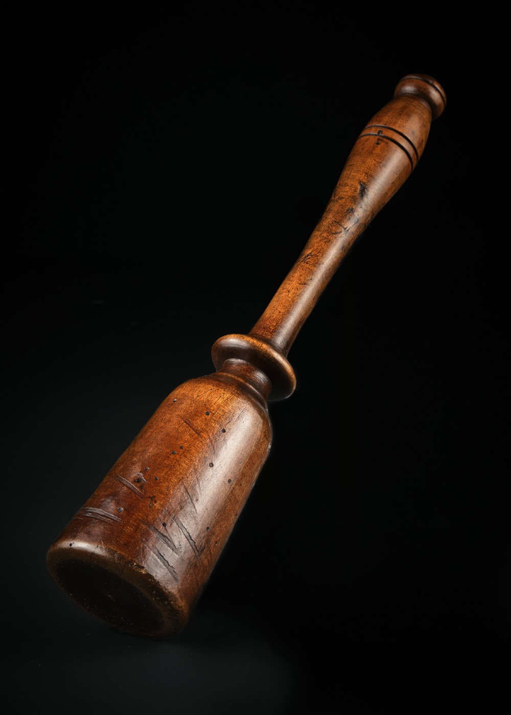 A turned dark brown sycamore wood potato masher featuring a contoured handle and bulbous head with visible age patina. View III