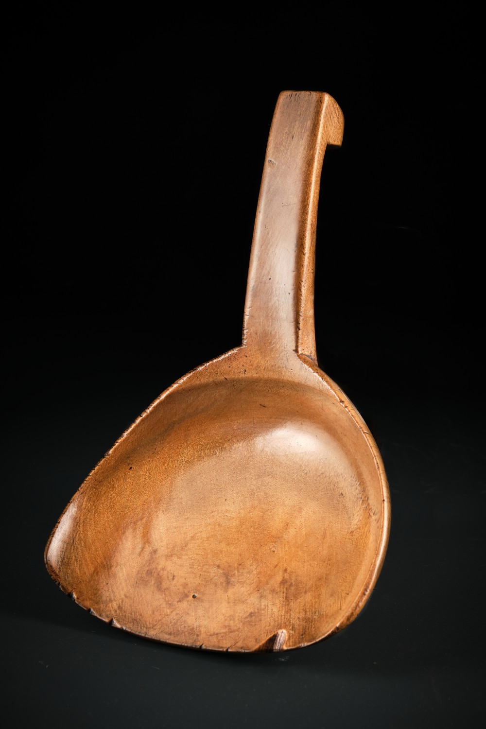 A hand-carved antique Welsh sycamore wooden scoop featuring a straight flat handle and a flared wide shallow bowl. View II