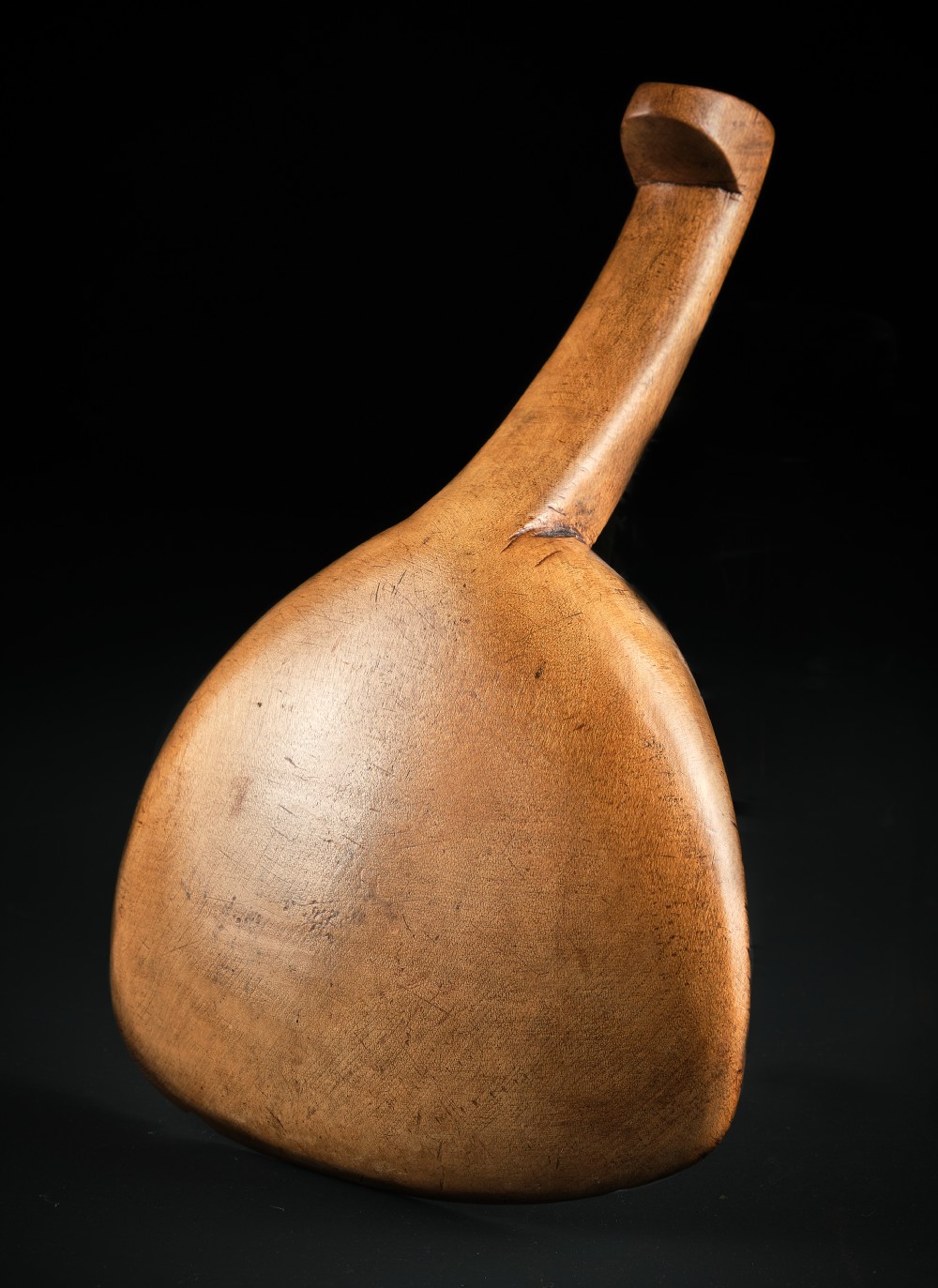 A hand-carved antique Welsh sycamore wooden scoop featuring a straight flat handle and a flared wide shallow bowl. View IV