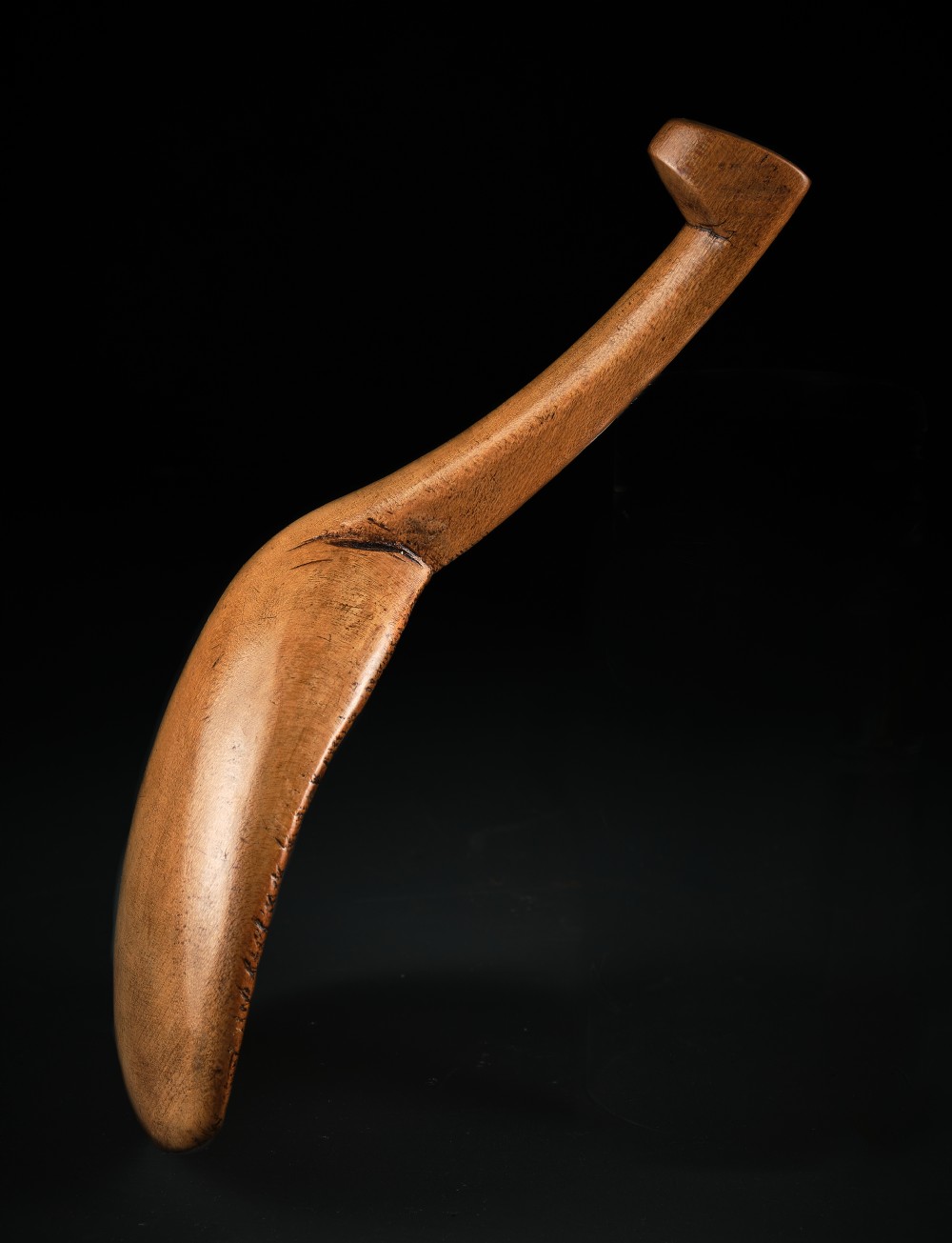 A hand-carved antique Welsh sycamore wooden scoop featuring a straight flat handle and a flared wide shallow bowl. View VI