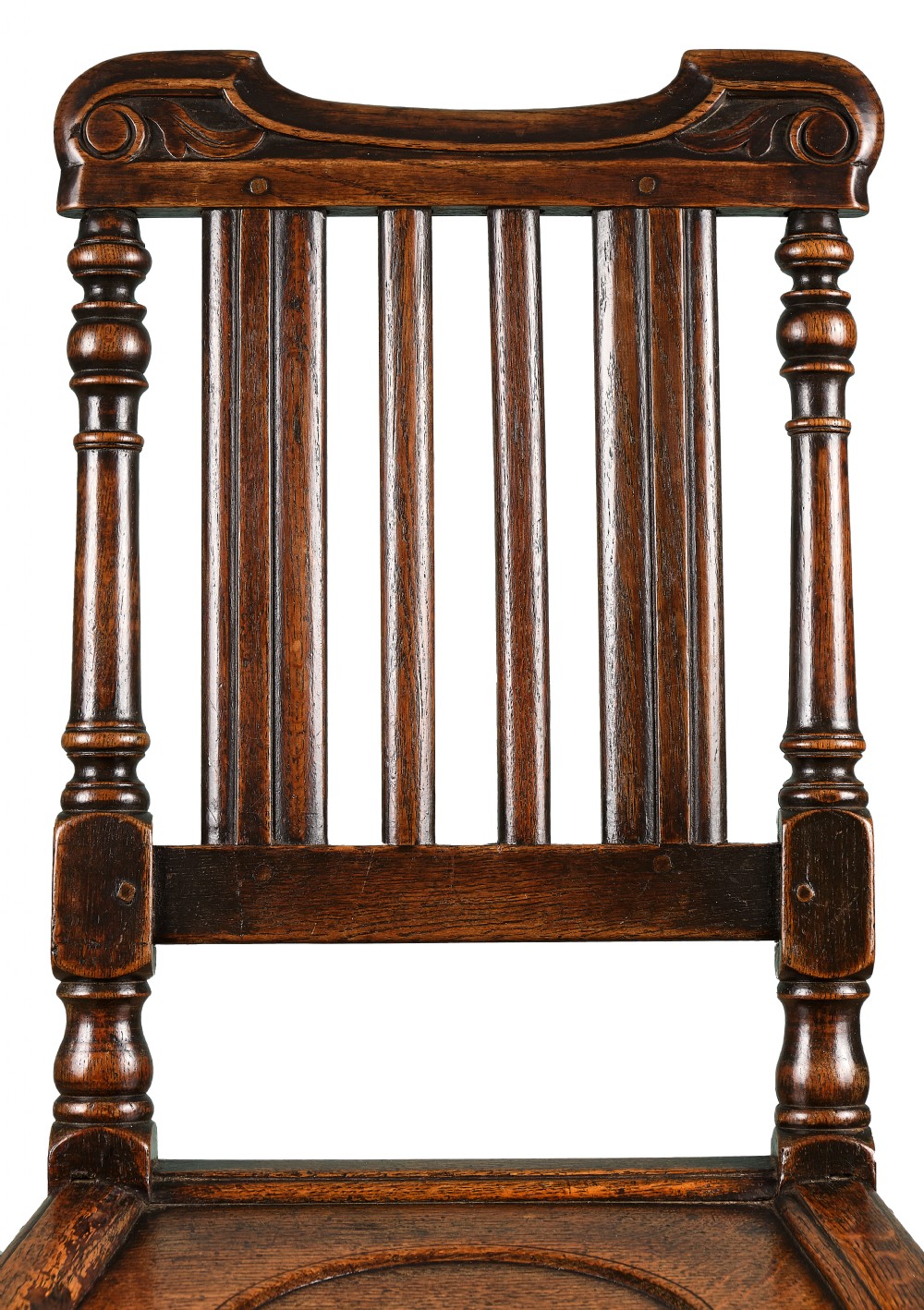 A late 17th-century dark oak side chair featuring turned legs, vertical back slats, and a carved crest rail. View III