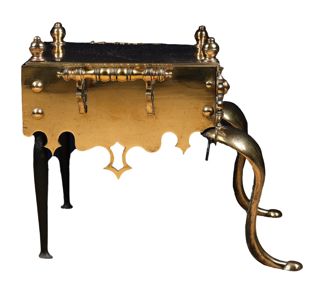 A polished brass Welsh footman hearth trivet with cabriole front legs, turned finials, carrying handles, and a pierced apron. View III