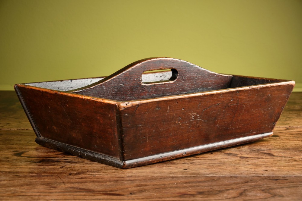 A dark brown antique pine cutlery tray featuring two open compartments separated by a central shaped divider with an integrated handle cut-out. View II