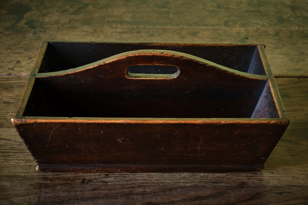 A dark brown antique pine cutlery tray featuring two open compartments separated by a central shaped divider with an integrated handle cut-out. View IV