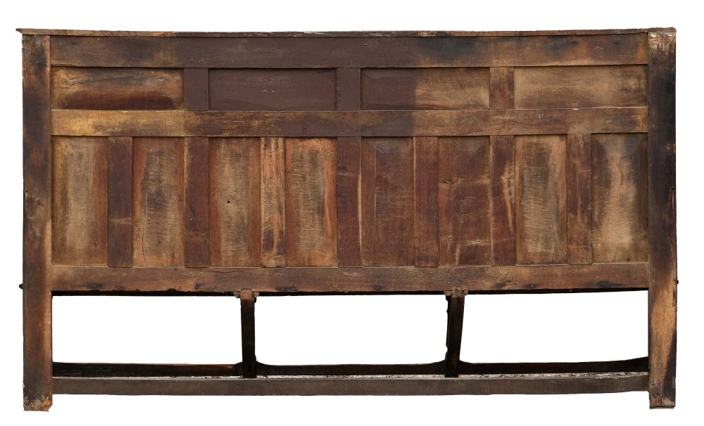 A high-backed dark oak settle with fielded panelling across the backrest, turned front legs, and a long wooden seat. View X