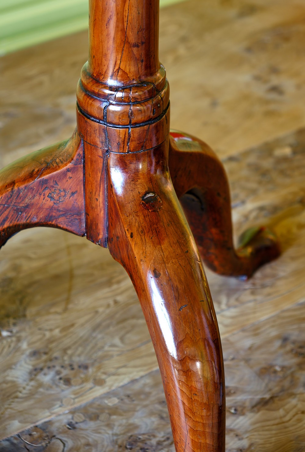 A small Georgian yew wood tripod table featuring a circular top, turned pedestal stem, and three cabriole legs with pad feet. View III