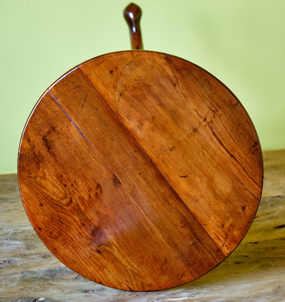 A small Georgian yew wood tripod table featuring a circular top, turned pedestal stem, and three cabriole legs with pad feet. View VI