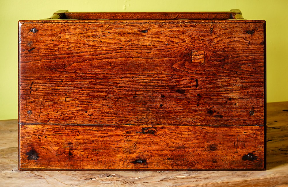 A Georgian oak side table featuring a single drawer with brass handles, a scalloped apron below, turned legs, and a perimeter stretcher. View VI