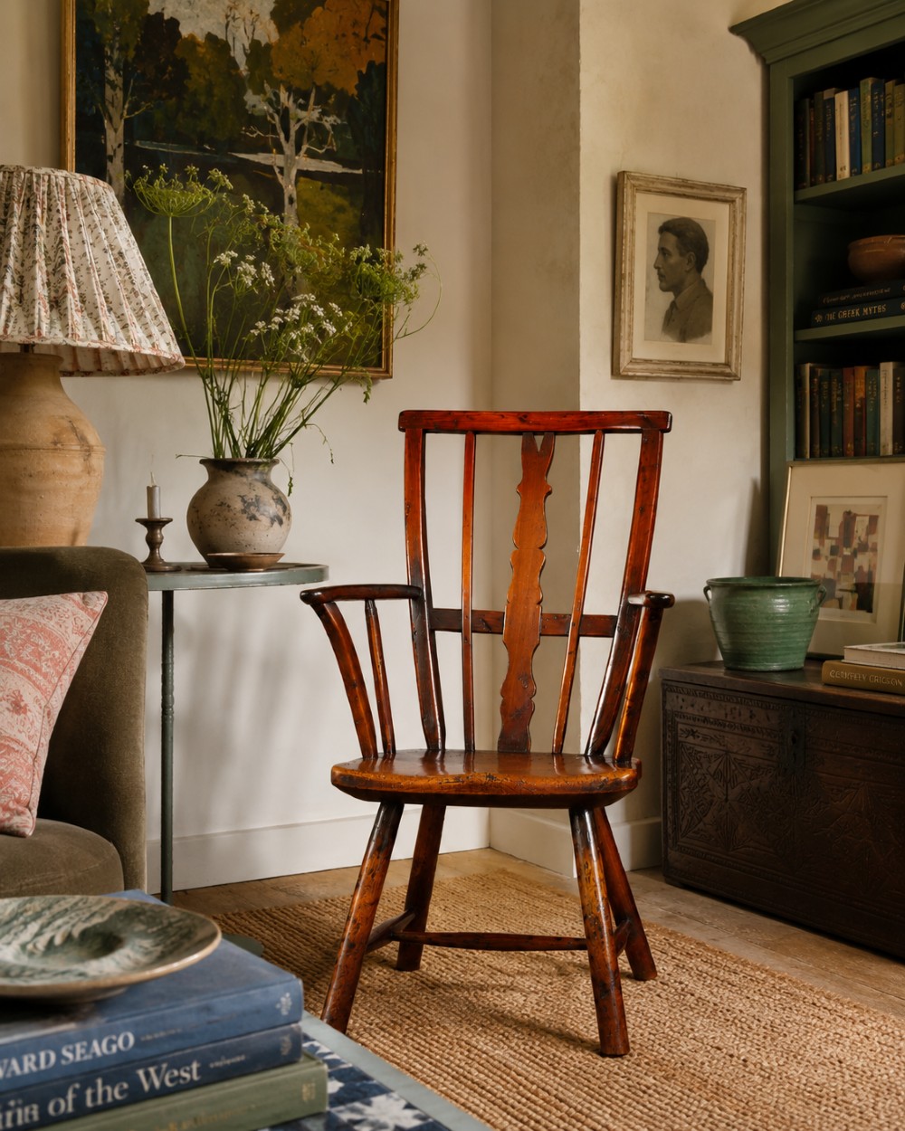 A primitive wooden Windsor armchair crafted from varied native hardwoods featuring a solid carved seat, shaped central back splat, tapered spindles, and splayed legs. View XI