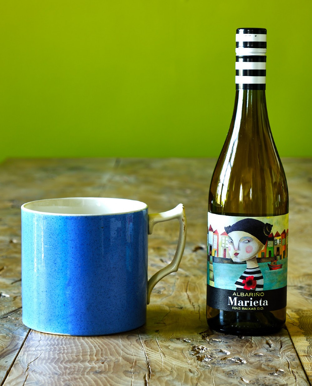 A large cylindrical ceramic mug featuring a speckled blue glazed exterior and a light cream interior with a matching handle. View IV