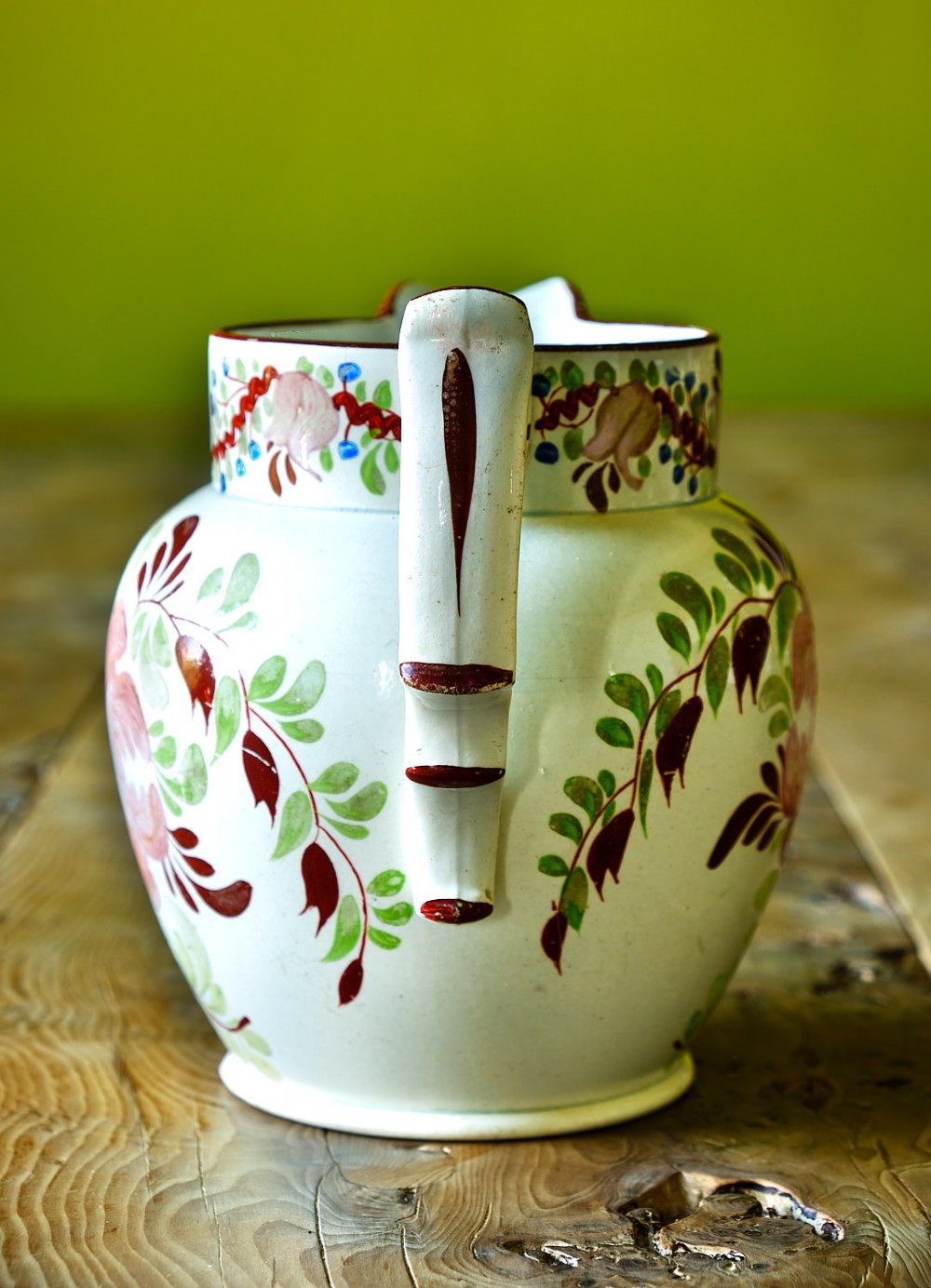 An early nineteenth-century pearlware ceramic jug with hand-painted floral motifs in pink, blue, and green enamels. View II