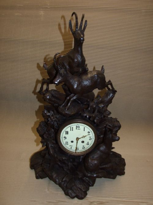 A Black Forest Carved Wood Mantle Clock with Mountain Goats