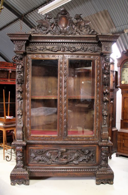 A Fantastic and Superbly Carved Walnut Cabinet / Bookcase in the Baroque Taste
