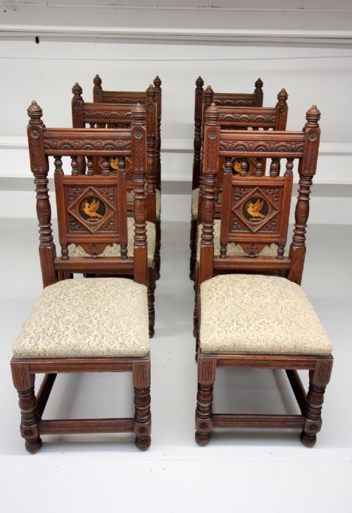 A Set of 6 Carved Oak Chairs Stamped Gillow Designed by Bruce Talbert