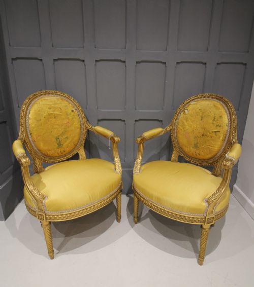 A Pair of Carved Giltwood Open Armchairs