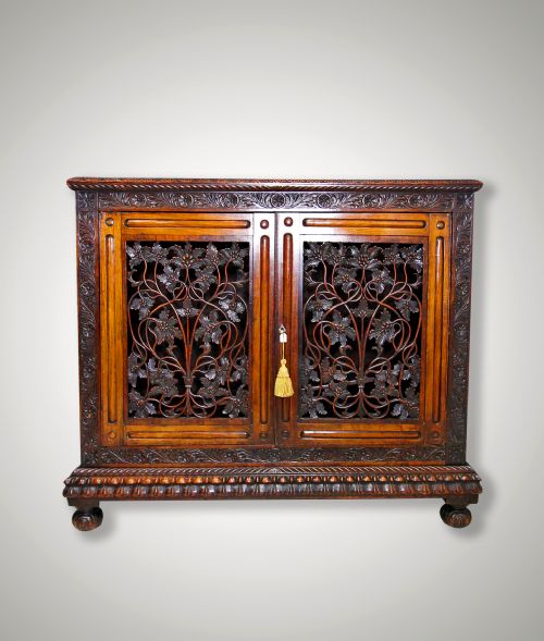 A Carved Oak Colonial Two Door Side Cabinet