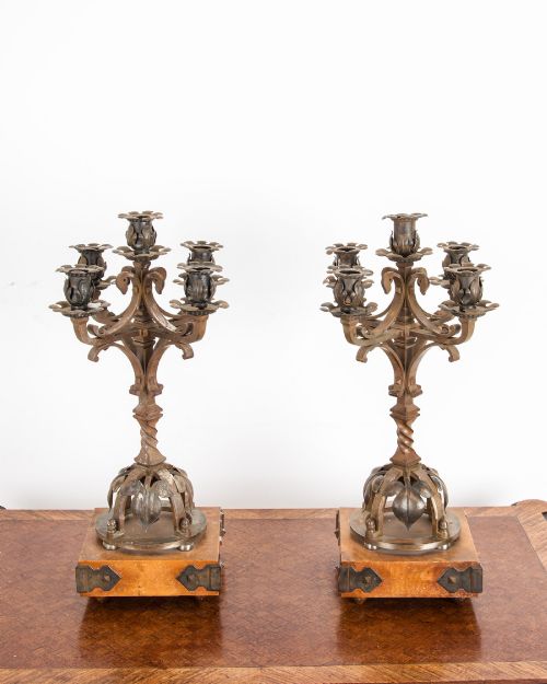 fig 2. A pair of five-branch Gothic Revival metal candelabra featuring foliate cups, twisted columns, and wooden bases with iron strapwork.
