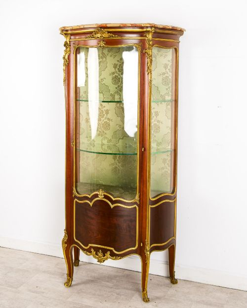 fig 2. An antique French Louis XV style vitrine cabinet featuring a marble top, glass panels, a fabric-lined interior with glass shelves, and gilt bronze mounts throughout.