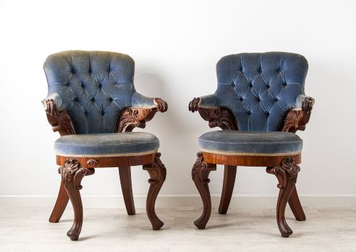 PAIR OF ANTIQUE CARVED MAHOGANY LIBRARY ARMCHAIRS