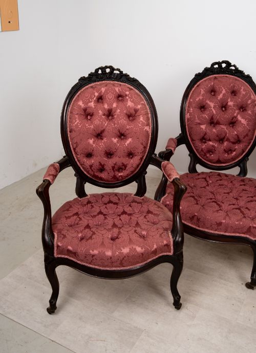 fig 3. A three-piece Victorian mahogany salon suite featuring a three-back settee and two matching armchairs upholstered in rose-pink deep-buttoned fabric.
