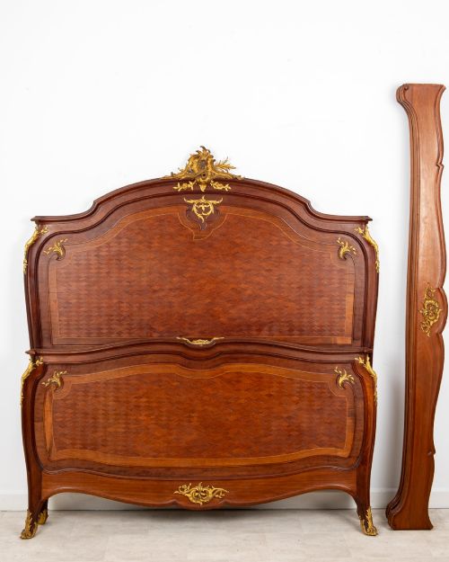 fig 2. An antique French Louis XV style bedstead crafted from kingwood with geometric parquetry veneers and gilded bronze ormolu mounts.
