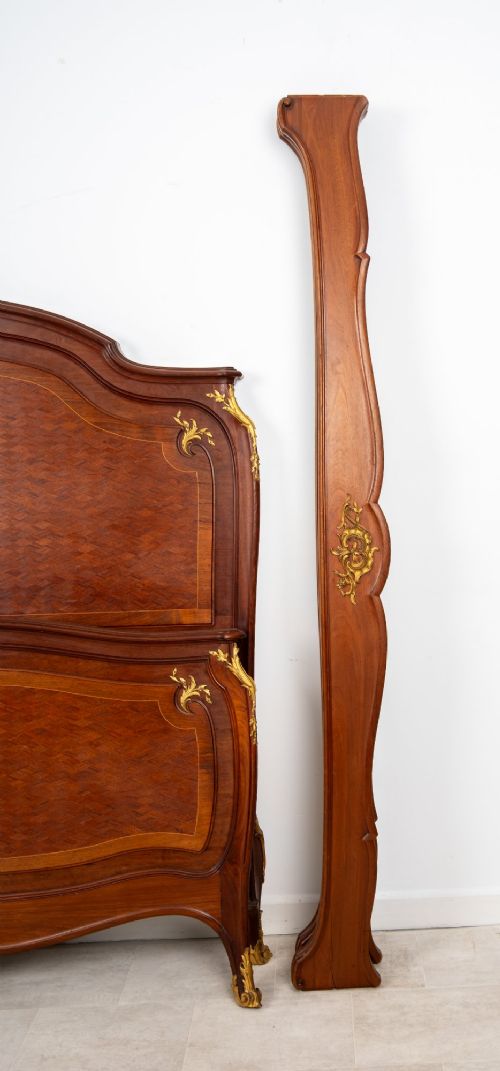 An antique French Louis XV style bedstead crafted from kingwood with geometric parquetry veneers and gilded bronze ormolu mounts. View IX