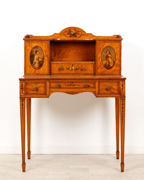 fig 1. An Edwardian hand-painted satinwood writing desk featuring a raised central cupboard superstructure decorated with painted oval portraits, floral swags, and square tapered legs.