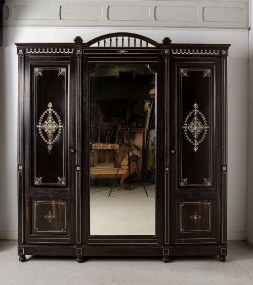 fig 4. A six-piece late Victorian ebonised bedroom suite featuring bone inlay, comprising a half-tester bed, mirror wardrobe, dressing table, marble-top washstand, nightstand, and towel rail.