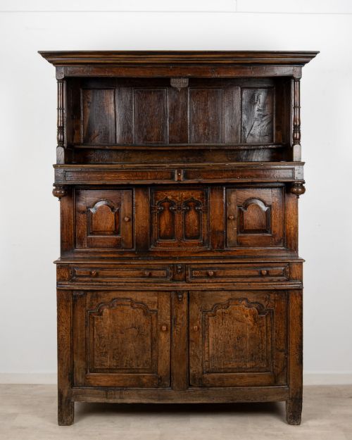 fig 1. An 18th-century dark Welsh oak cwpwrdd tridarn three-tier press cupboard featuring fielded panels and turned canopy posts.