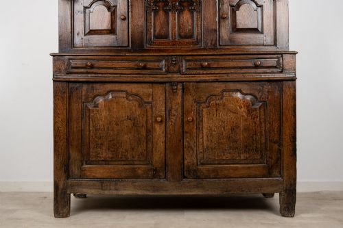 fig 3. An 18th-century dark Welsh oak cwpwrdd tridarn three-tier press cupboard featuring fielded panels and turned canopy posts.