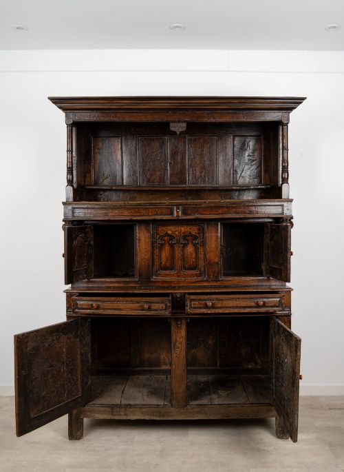 fig 7. An 18th-century dark Welsh oak cwpwrdd tridarn three-tier press cupboard featuring fielded panels and turned canopy posts.