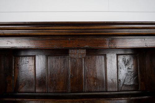 fig 8. An 18th-century dark Welsh oak cwpwrdd tridarn three-tier press cupboard featuring fielded panels and turned canopy posts.